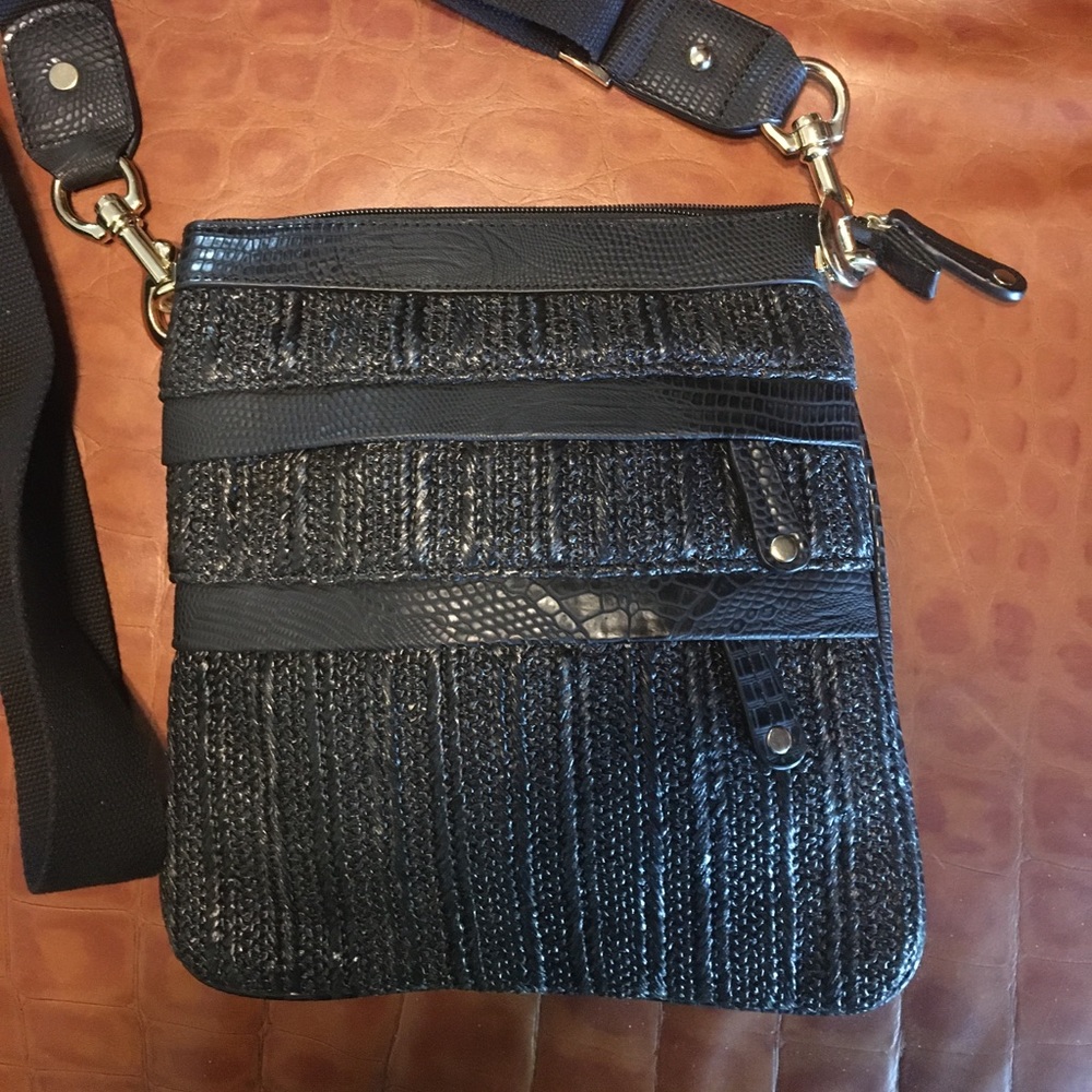 Sondra Roberts Black woven Raffia crossbody with lizard trim. Adjustable strap.